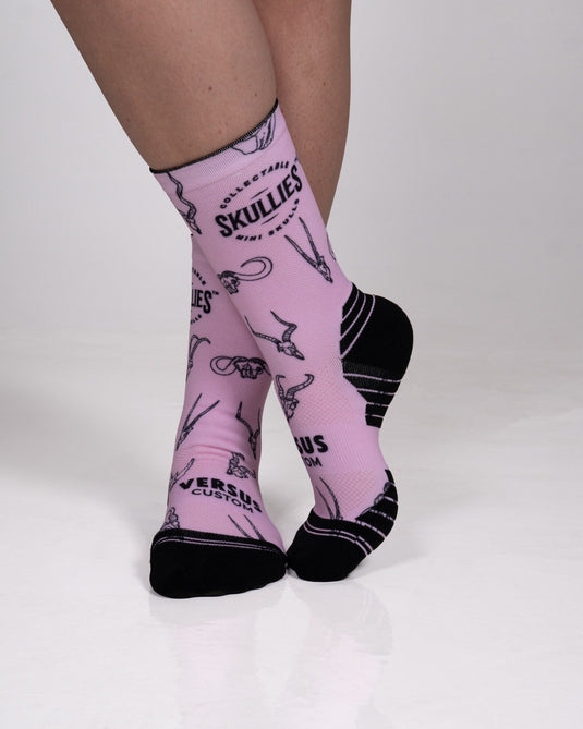 Pink Skullies crew socks showing black heel and toe panels and Versus Custom branding