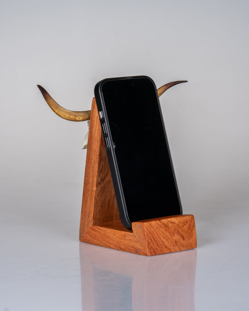 Load image into Gallery viewer, Cellphone Mount in use - phone resting in the rosewood cradle with longhorn Skullie horns behind
