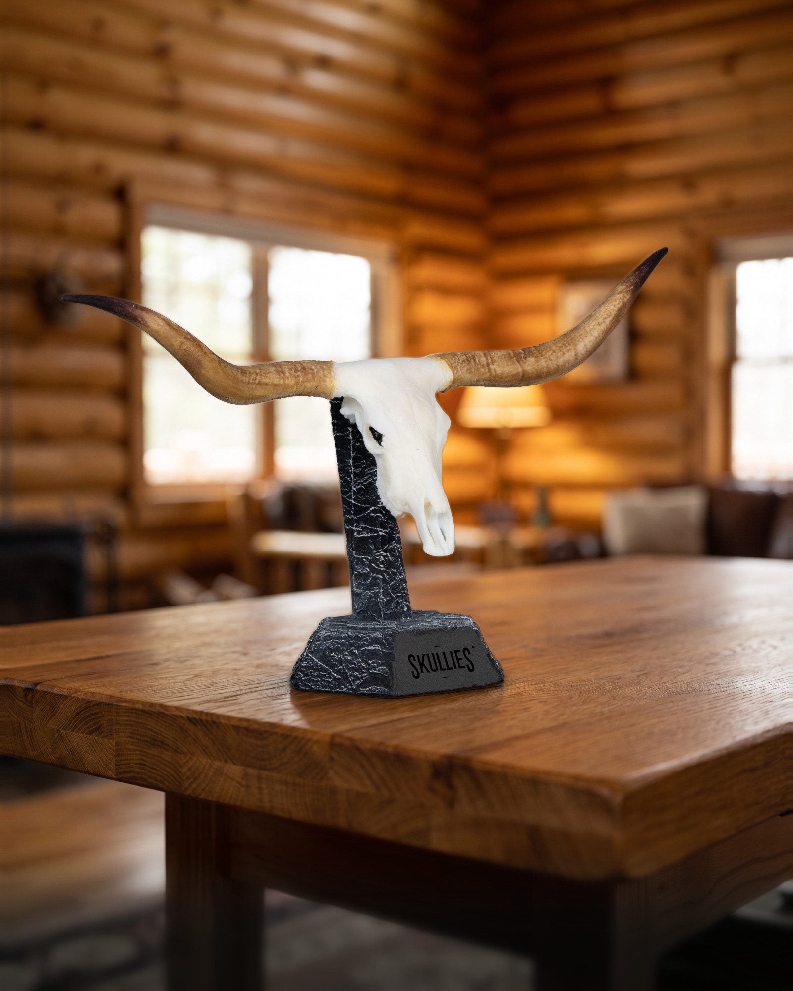 Texas Longhorn Skullie on a Skullies display pedestal in a log cabin